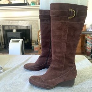 Brown suede knee high wedge boots.